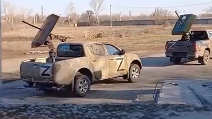 Convoy-of-ISIS-style-Toyota-and-Mitsubishi-pickup-trucks-used-by-the-Russian-military-in-Ukraine-driving-on-a-street