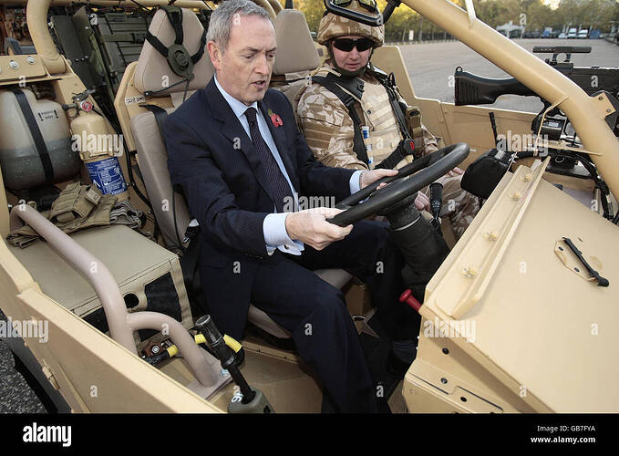 defence-secretary-john-hutton-is-shown-the-controls-of-the-armys-jackal-GB7FYA