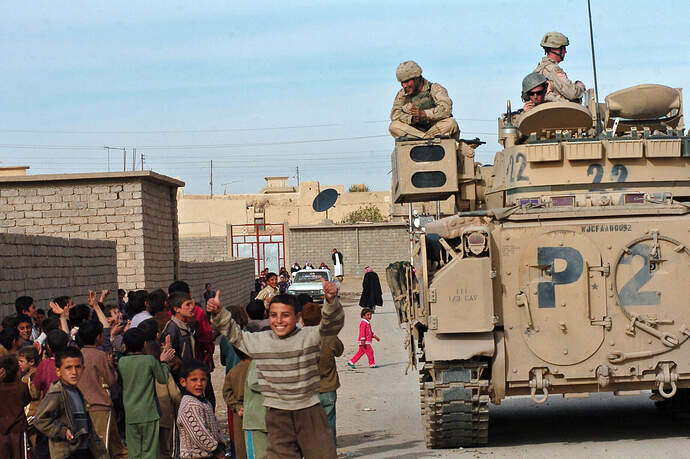 US_Navy_051125-N-9885M-560_Iraqi_children_in_Khan_as_Sur,_Iraq,_gather_around_a_U_S__Army_M3A3_Bradley_tank,_from_3rd_Armored_Cavalry_Regiment,_Tiger_Squa