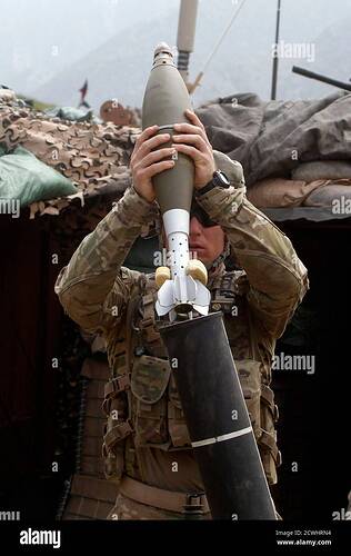 us-army-specialist-blair-brown-loads-a-120mm-mortar-shell-during-a-fire-fight-between-taliban-fighters-and-afghan-and-us-soldiers-from-alpha-company-2nd-battalion-27th-infantry-regiment-