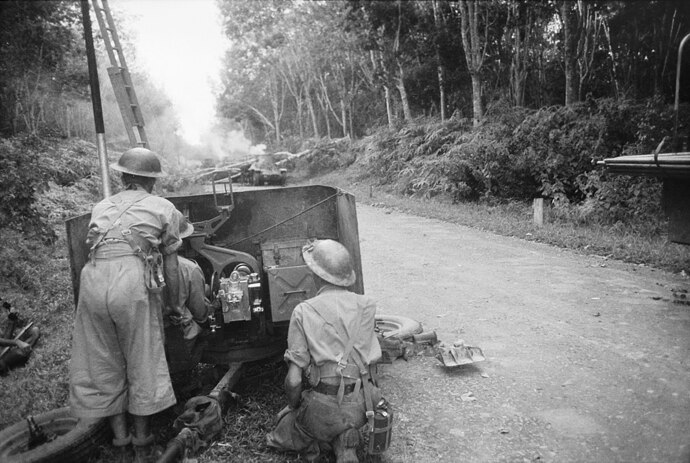 1280px-Australian_2-pdr_anti-tank_gun_in_action_at_Bakri_on_the_Muar-Parit_Sulong_Road
