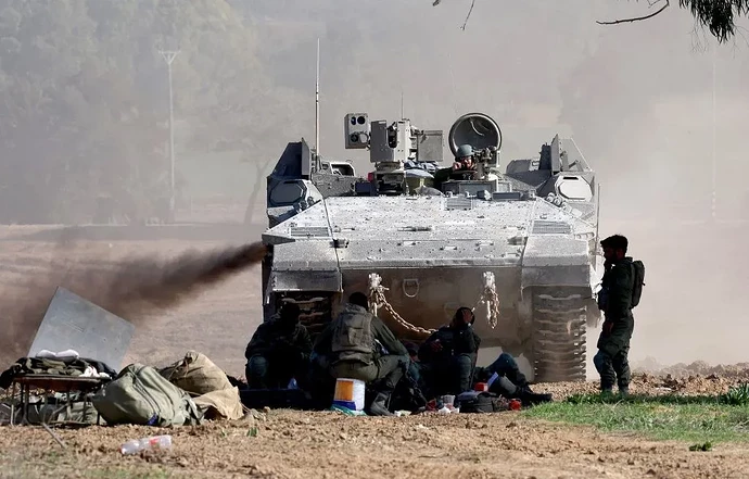 1200x768_a-picture-taken-from-a-position-in-southern-israel-along-the-border-with-the-gaza-strip-on-december-29-2023-shows-an-israeli-army-apc-armored-personal-carrier-rolling-on-amid-continuing-battles-betw