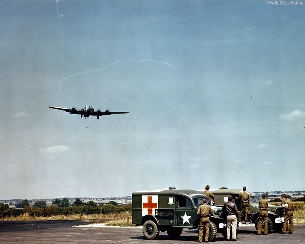 Crippled_8th_AF_B-17_in_pattern_over_WC-54_Ambulances_England_44